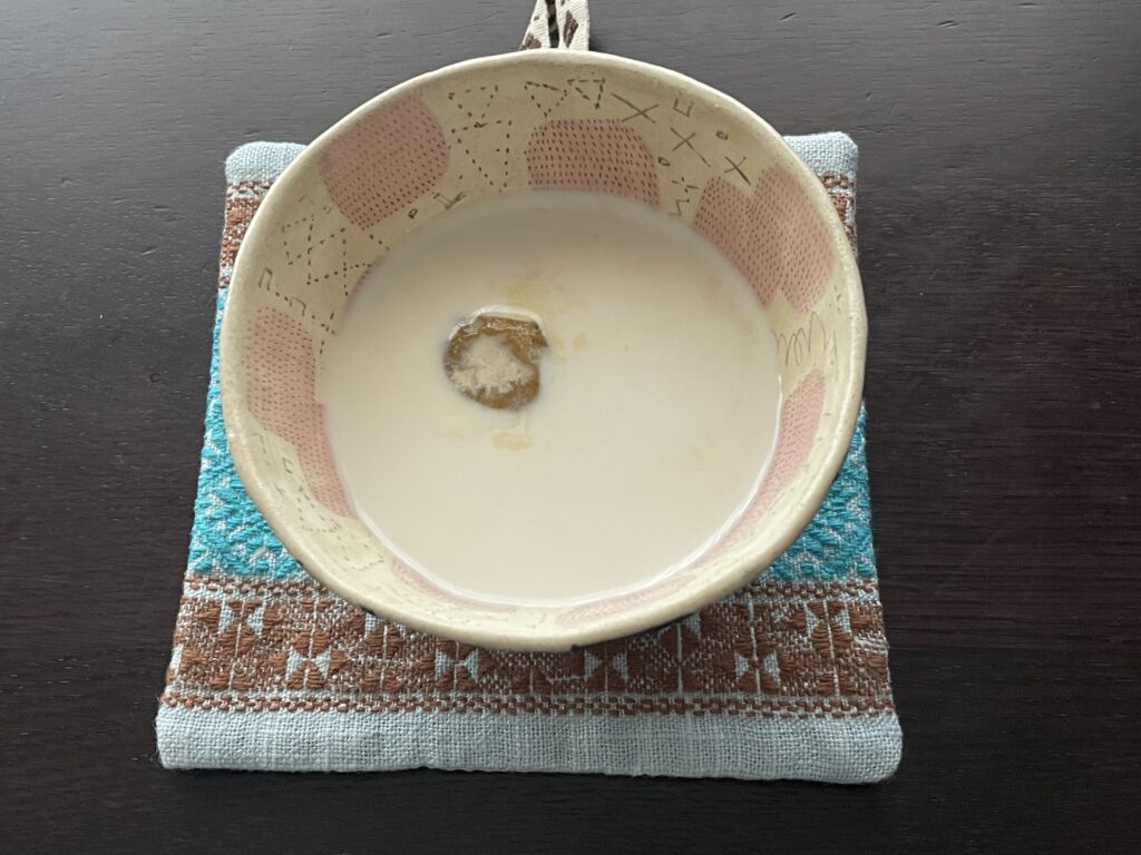 今井真実さんレシピの「梅アールグレイ」を40代主婦が作り、ミルクを混ぜたもの。佐藤尚理さん作陶のボウルに注いでいる。下にはmianiuさん作のこぎん刺しのコースターを敷いている。