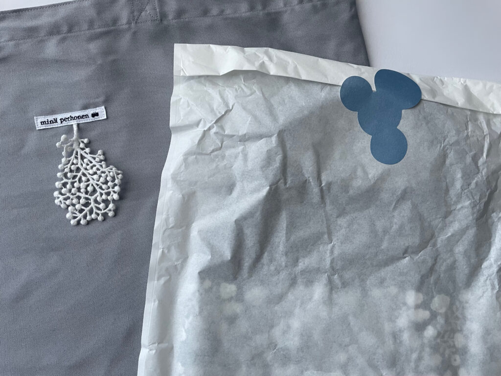 ミナペルホネンKOTIでの購入品写真。包装紙に包まれており、soda water柄のシールで封をしてある。