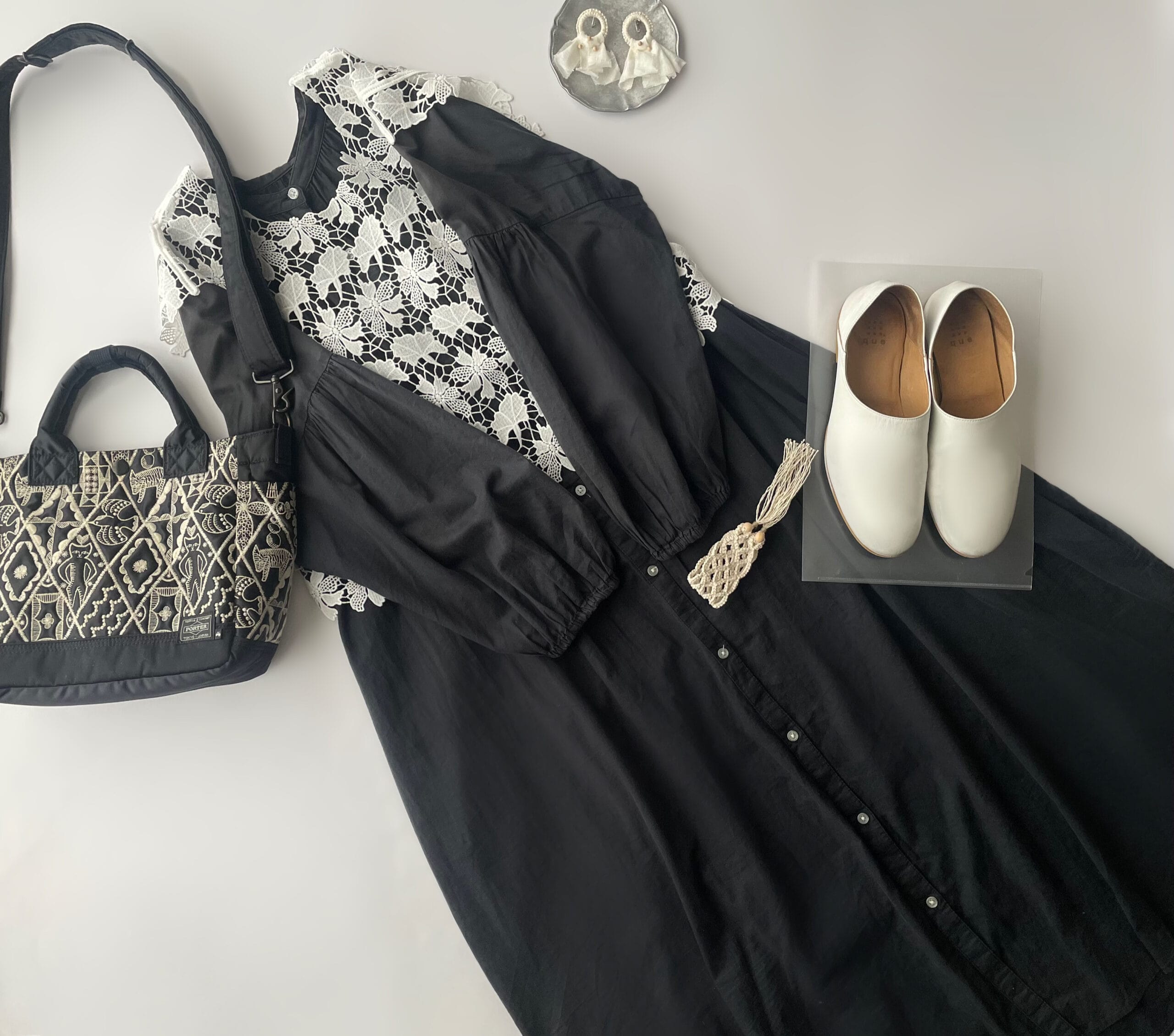 somari imaginationの白のレースベストを使ったコーデ。GUの黒のバンドカラーシャツワンピースと合わせたフラットレイ画像。