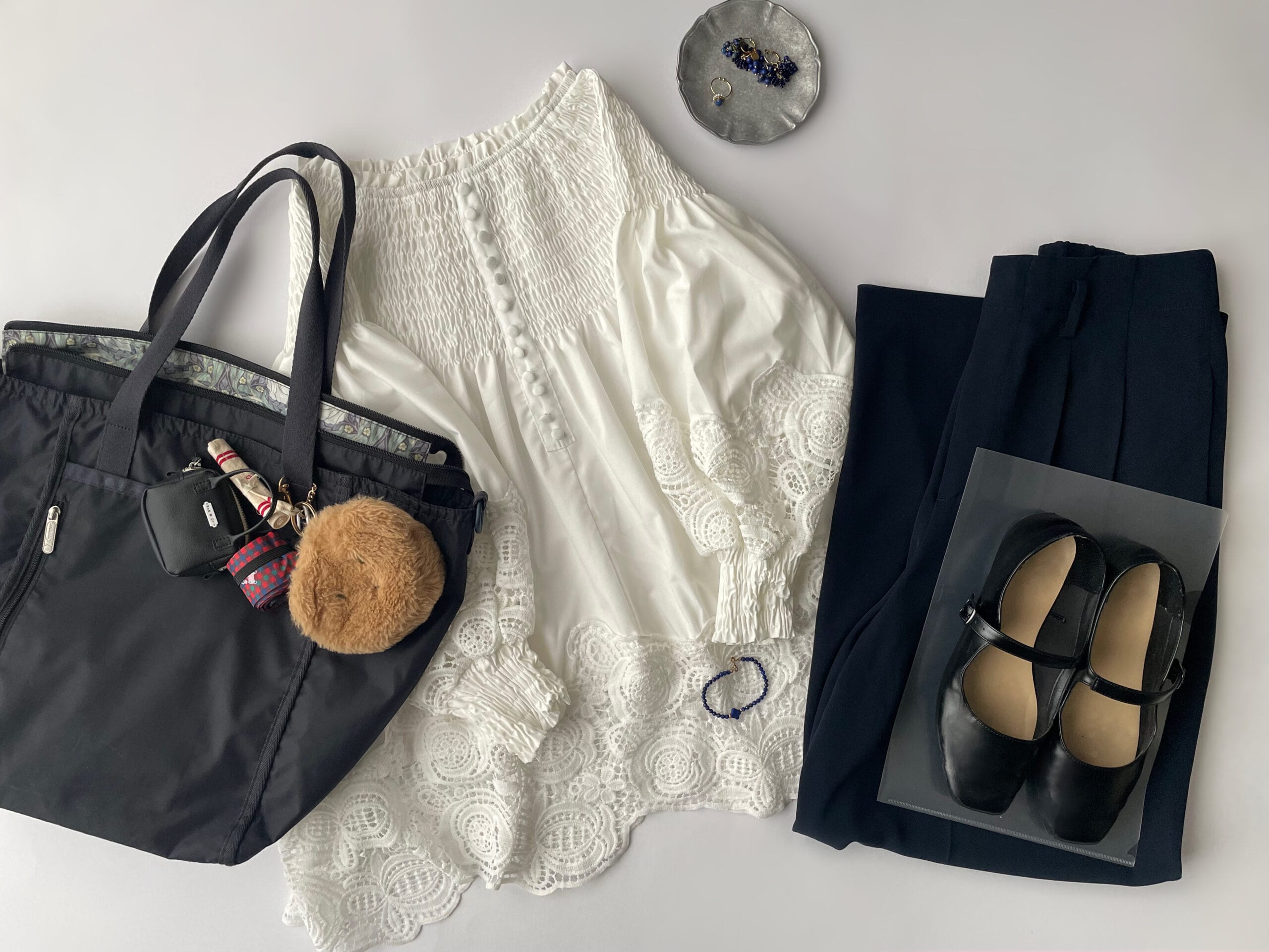 40代女性の2025年9月中旬コーデ、ボンジュールサガンのレースブラウスにGUのポリエステル素材のネイビーのパンツを合わせているフラットレイ画像。