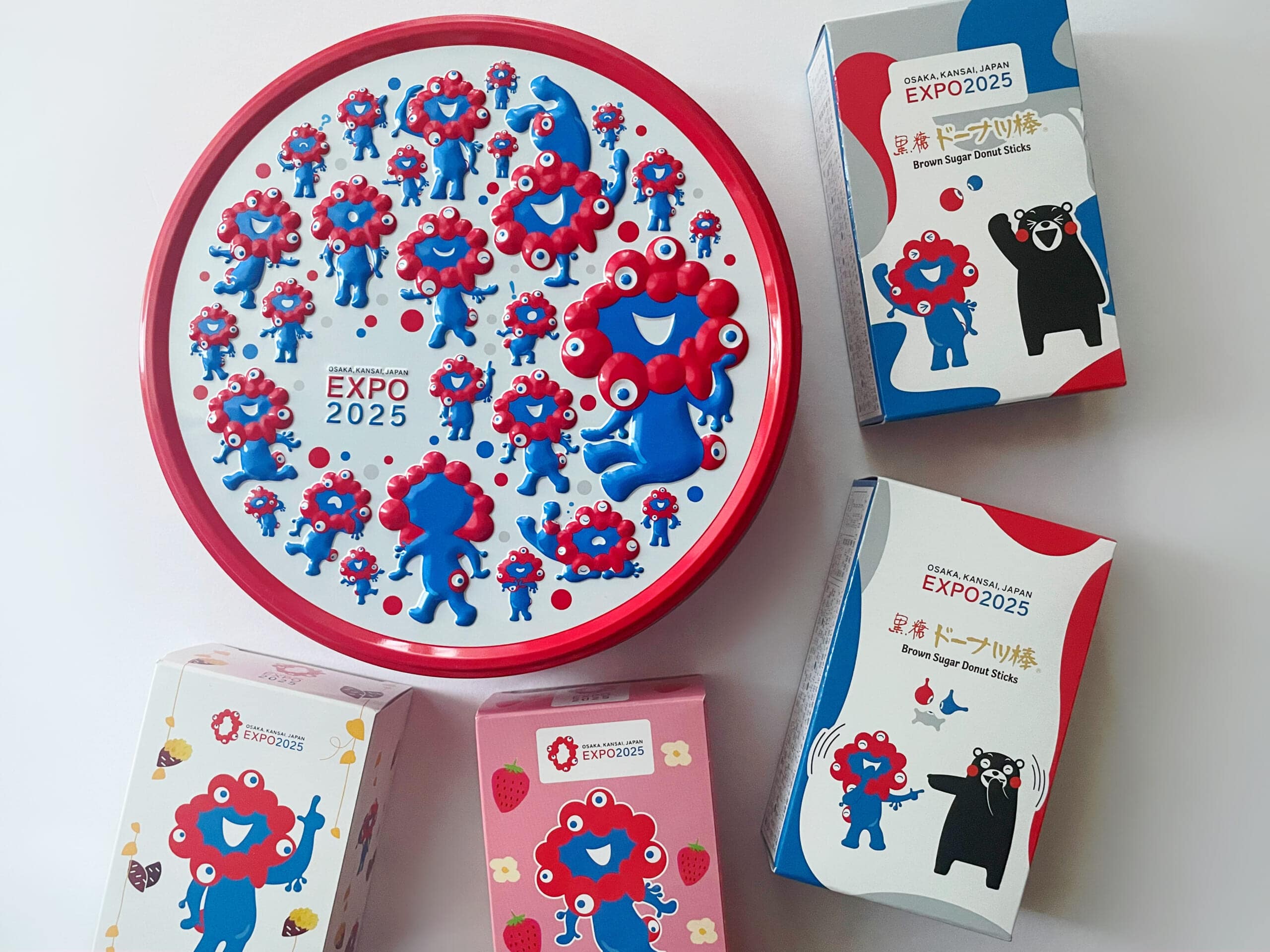 ミャクミャク缶と黒糖ドーナツ棒、スイートポテトのいちご味と鳴門金時味。