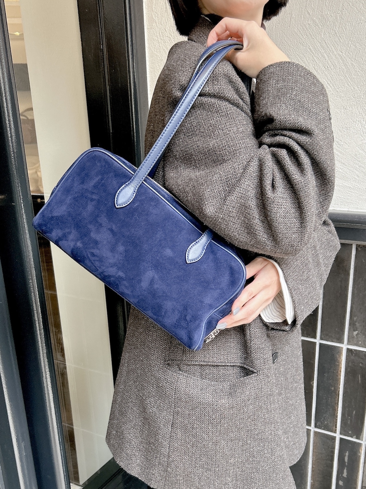 トゥティエ ロケスモールバッグの日本限定ネイビーを肩がけ