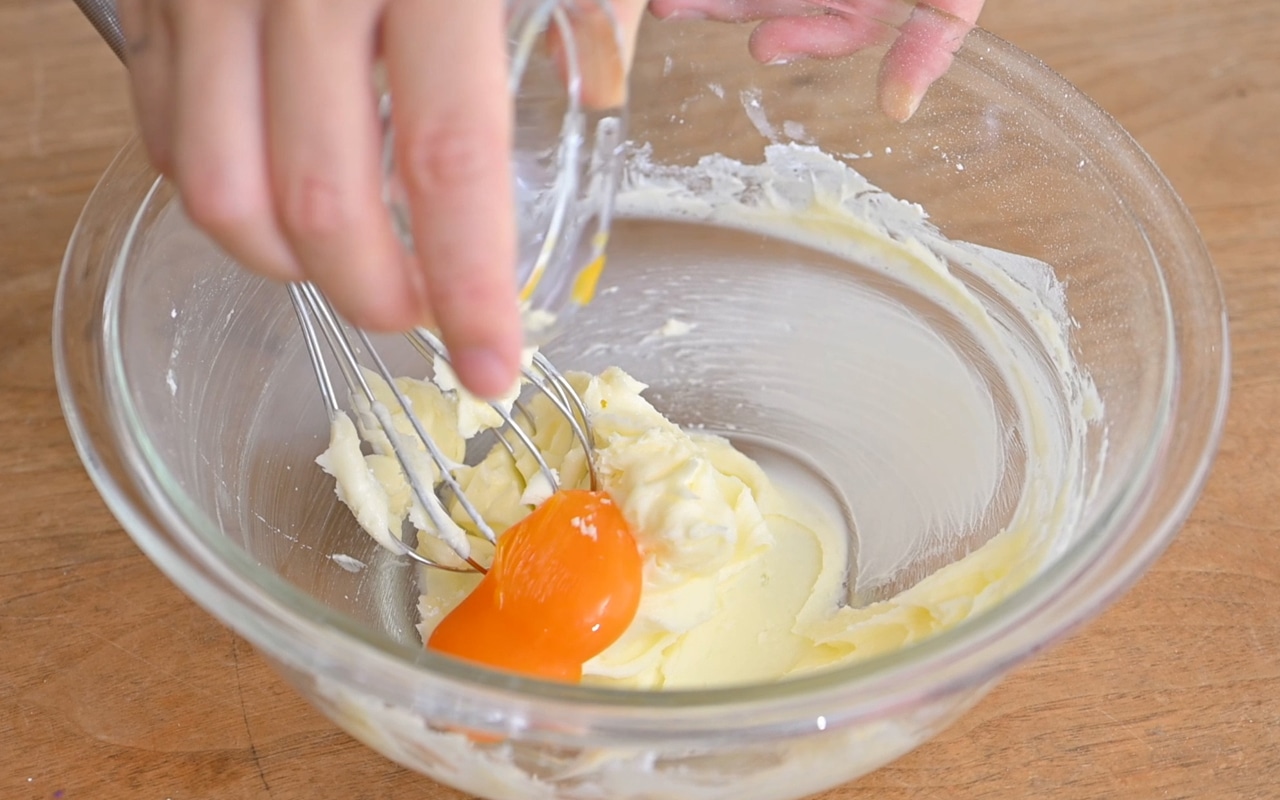 ①に粉砂糖をふるって加え、押し付けるようにしながら粉っぽさがなくなるまで混ぜ、卵黄を加えなじむまで混ぜる。
