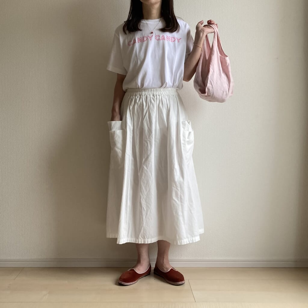 控えめピンクが主役。50代女性の大人のピンクスタイル。ホームスパンのダブルポケットスカート着画。