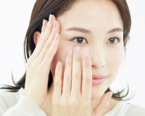 目元をストレッチしながら乳液をくるくるとなじませる様子